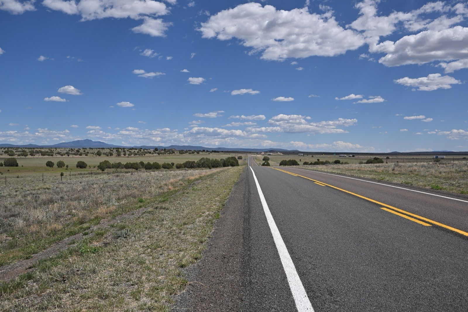 Two-lane Historic Route 66 near Crookton Road, Arizona, running straight across grassland